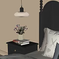 Stylish Black Bedside Table with Vase of Flowers Stacked Books and Drawer