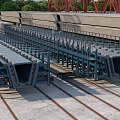 Industrial Steel Bridge Structure Component With Red Supports Blue Frame And Rail Tracks