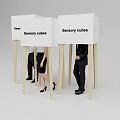 Sensory Cubes With White Panels And Wooden Poles Among Standing People