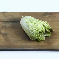 Fresh Chinese cabbage placed on wooden cutting board in bright white background