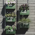 Hanging Basket Plants with Various Greenery Mounted on Gray Brick Wall