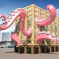 Giant Pink Octopus Tentacles Art Installation Wrapped Around Yellow Building With Modern High Rise Background