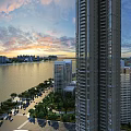 Scenic Waterfront Landscape With Tall Buildings Trees Road And Sunset Sky