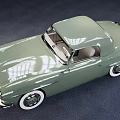 Green Vintage Convertible Car With White Wall Tires And Classic Design