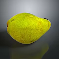 Ripe Yellow Pear With Speckled Skin On Dark Reflective Surface