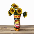 Bright Yellow Sunflowers In Colorful Decorative Vase With Floral Pattern On Wooden Table