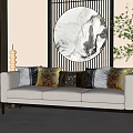 White Three-Seater Sofa With Colorful Patterned Cushions And Circular Marble Wall Art