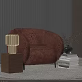 Wooden Table Lamp with Cube Base Beside Brown Furry Armchair and Book Stack