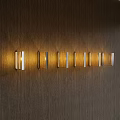 Modern Wall Lamps With Metal Frames Emitting Warm Light On Wooden Wall