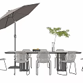 Modern Outdoor Table Setup With Woven Chairs Umbrella Vase And Green Plant