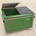 Green Metal Trash Bin With Open Lid And RM 03 Label On Concrete Ground
