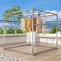Metal Frame Clothes Drying Rack With Hanging Clothes On Outdoor Balcony