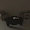 Beige Armchairs And Black Round Coffee Table With Open Book In Minimalist Space