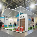 Chusco Exhibition Booth With White Structure Blue Elements Green Lawn And People