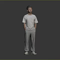 Man Standing Hands in Pockets Wearing White T-Shirt Gray Sweatpants White Sneakers on Gray Background