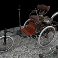 Vintage Tricycle With Wooden Seat Metal Frame And Large Wheels On Stone Pavement