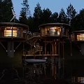 Circular Wooden Cabins on Waterfront Surrounded by Forest and Wind Turbine