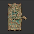 Ornate Bronze Door Handle With Intricate Facial Carvings And Decorative Patterns