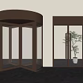 Brass Frame Revolving Door And Glass Double Door With Green Plant In Modern Interior