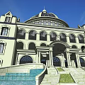 Classical Hotel Building with Grand Dome Symmetrical Facade Ornate Entrance and Blue Sky Background