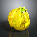 Shiny Yellow Leaf Wrapped Fruit With Green Top On Black Background