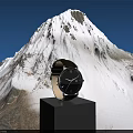 Elegant Watch On Black Cube Pedestal Against Snowy Mountain Blue Sky