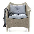 Beige Woven Leisure Chair With Light Blue Cushions Dark Blanket And Metal Legs