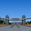 Modern Architectural Entrance Gate With Twin Pillars Arch Structure And Landscaped Trees