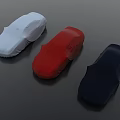 Three Covered Cars In Light Blue Red Dark Blue On Smooth Black Surface