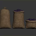 Three Burlap Sacks Filled with Fresh Purple Fruits on Dark Surface