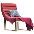 Red Lounge Chair with Gray Patterned Pillow and Pink Blanket on Golden Metal Legs