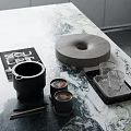Stylish Decorative Ornaments Set With Black Mug Wooden Tray And Glass Cups On Marble Countertop