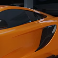 Orange Sports Car With Rear Wing And Aerodynamic Front Design On Track Surface