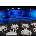 Modern Conference Venue With Blue Lighting Large Screen And Round Tables