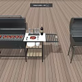 Outdoor Grill Equipment With Open Grill Plates Wine Bottle And Closed Grill On Wooden Deck
