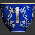 Blue Ceramic Cup With Orange Interior And Gold Handle Floral Patterns