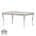 White Ornate Dining Table Featuring Intricate Carved Legs And Smooth Surface