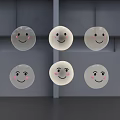 Multiple Round Transparent Objects With Smiling Faces Arranged Against Gray Background