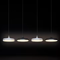 Four Modern White And Black Pendant Lights Hanging Illuminated On Dark Background