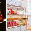 Modern Dessert Shop Interior With Glass Display Cases Stone Countertops And Pendant Lights