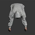 A Man Wearing Gray Hoodie And Gray Pants Squatting On Black Floor With Gray Background