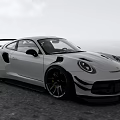 Silver Porsche Sports Car Widebody Design Black Wheels Sporty Spoiler On Coastal Road Sky Ocean