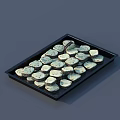 Round Light Green And Dark Brown Cookies On Black Tray With Layered Arrangement