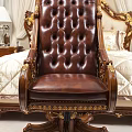 Luxurious Brown Leather Office Chair With Gold Carved Accents Wooden Armrests And Tufted Backrest