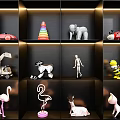 Variety of Assorted Dolls Displayed on Black Shelves Including Flamingo Elephant and Car