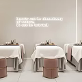 Modern Beauty Spa Treatment Room Interior With White Treatment Beds And Stools