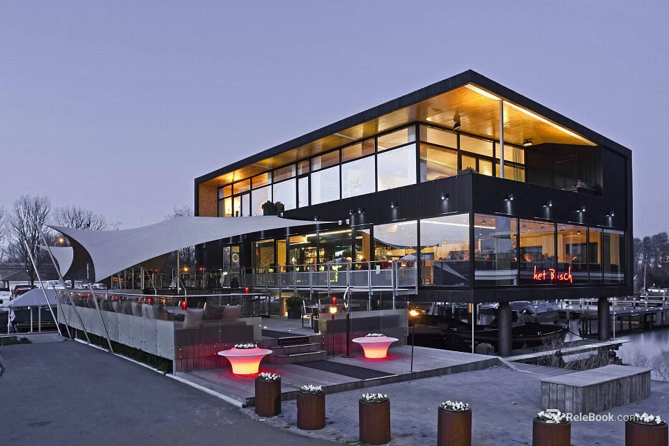 Modern Building Exterior With Large Glass Windows Black Walls And Terrace Red Lights Outdoor Seating 3d model 