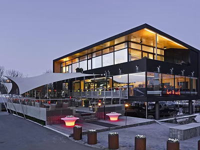 Modern Building Exterior With Large Glass Windows Black Walls And Terrace Red Lights Outdoor Seating 3d model