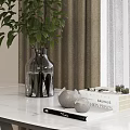 Green Leafy Plants in Transparent Vase on White Table with Curtain and Decorative Books