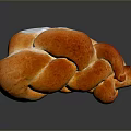 Freshly Baked Braided Bread With Shiny Golden Brown Crust And Soft Texture